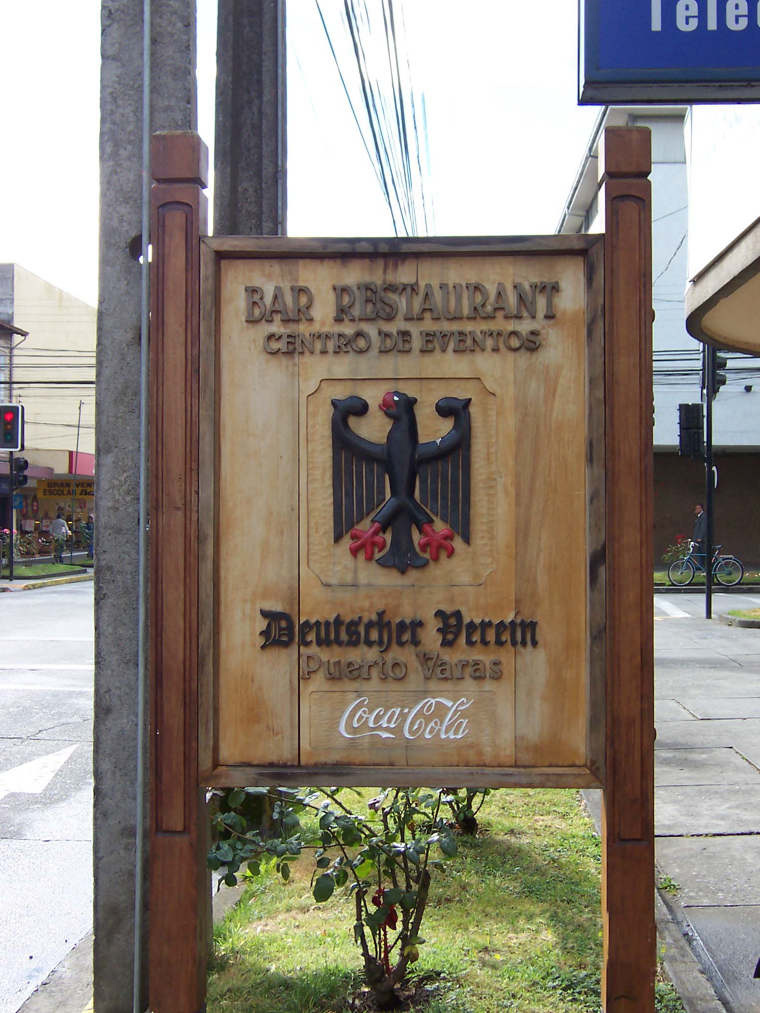 Wood-carved street sign beckoning diners to the Club Alemán's bar and restaurant. The German eagle greets Atlanta's global beverage in South America